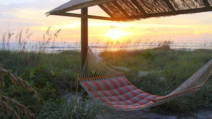 Beach front photo with one of the hammocks at Suntan Terrace Beach Resort